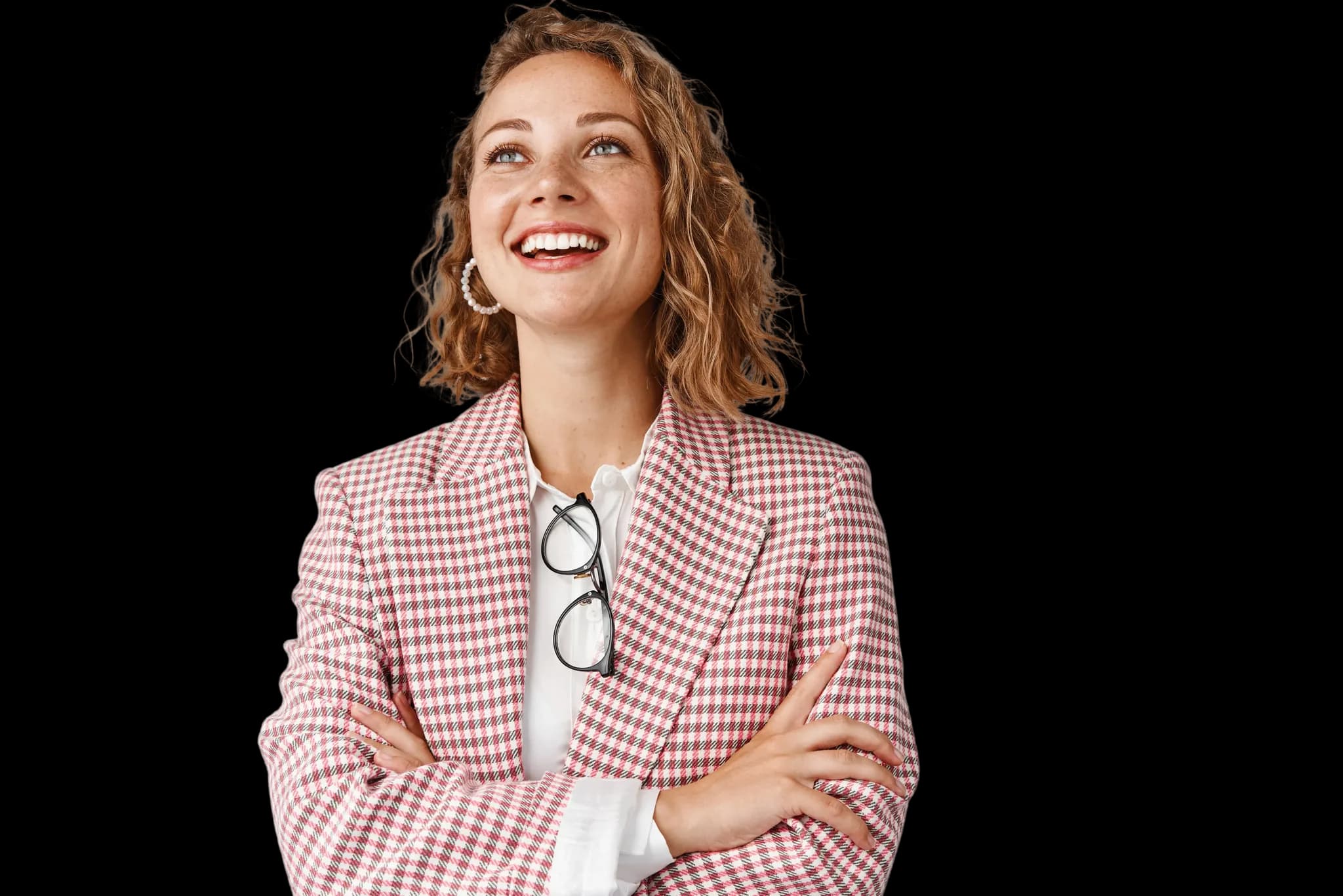 A smiling professional looking upward with a hopeful expression